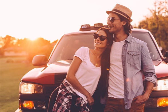 beautiful-young-smiling-virgo-man-and-leo-woman-looking-thoughtful-while-bonding-to-each-other-and-leaning-at-their-pick-up-truck