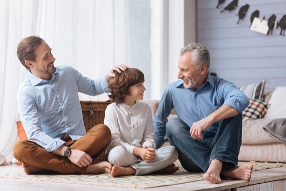 Father, son and grandfather talk on the porch